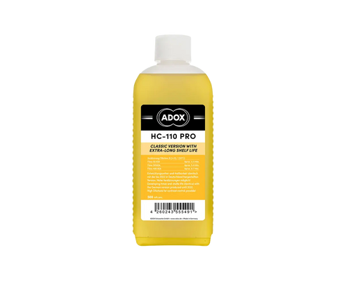 A yellow liquid-filled bottle with a white cap and black-and-yellow label, branded as ’adox hc-110 pro.’