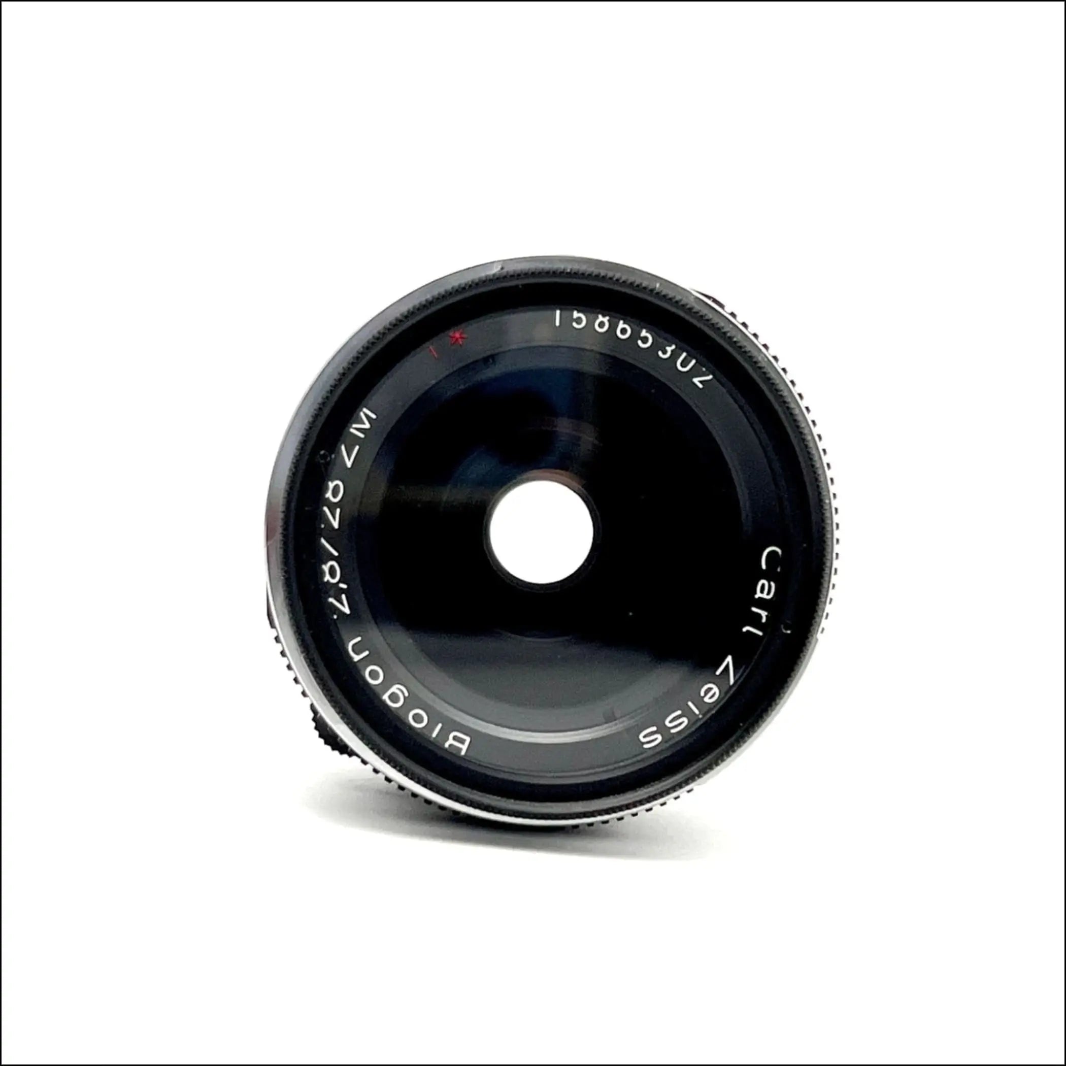 Black carl zeiss biogon 87mm f/2.0 lens with a sleek, metallic finish and engraved markings on the barrel.