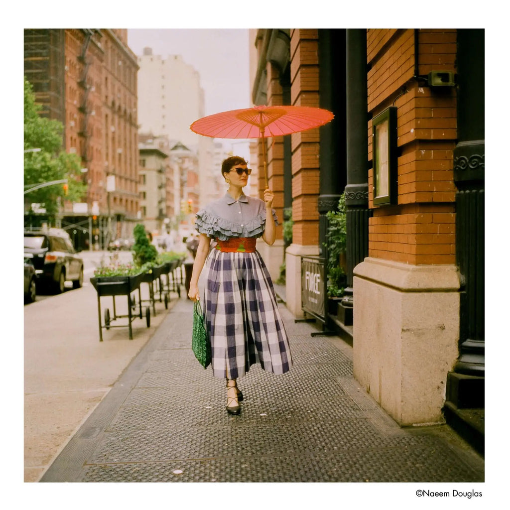 Vibrant red paper parasol with a traditional wooden frame