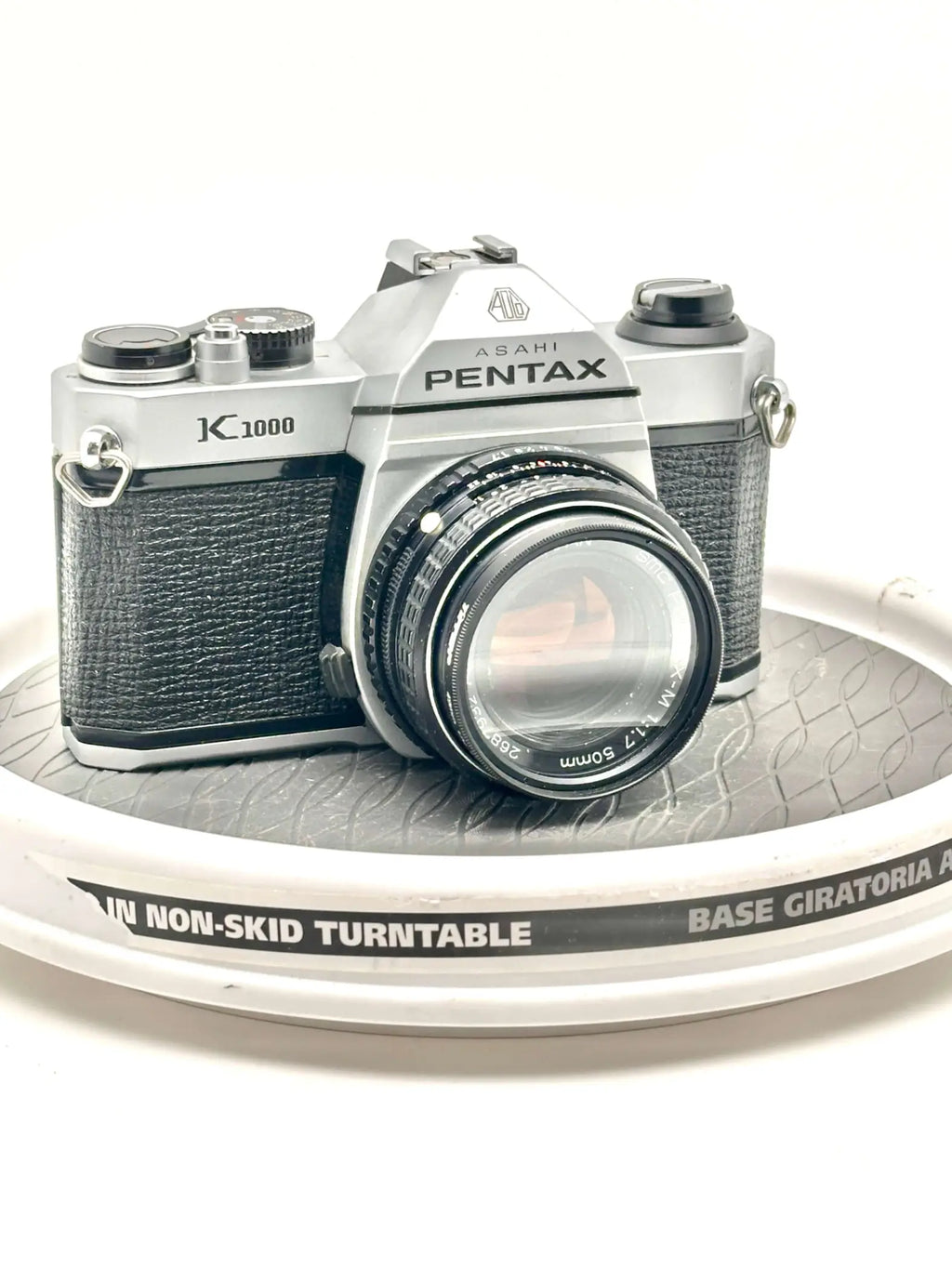 Silver and black asahi pentax k-1000 film camera with a textured leather grip.