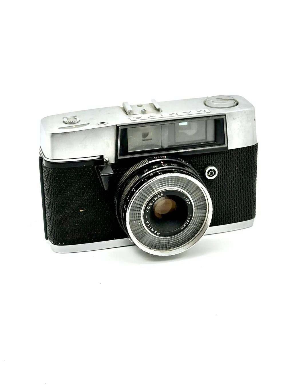 Silver and black mamiya film camera with a textured grip and chrome lens ring.