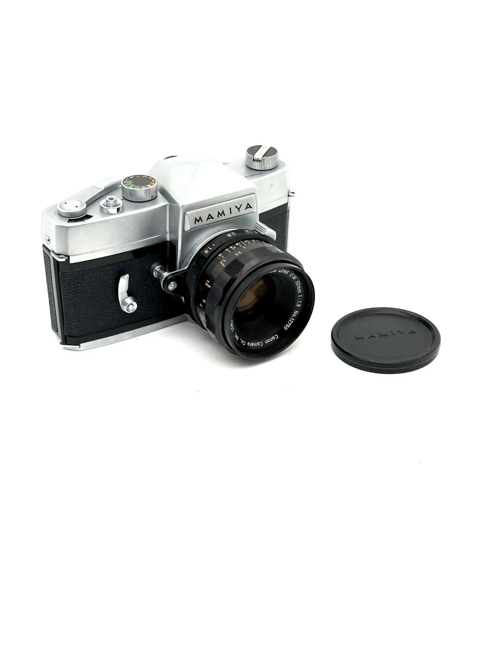 Silver and black mamiya film camera with a mounted lens.