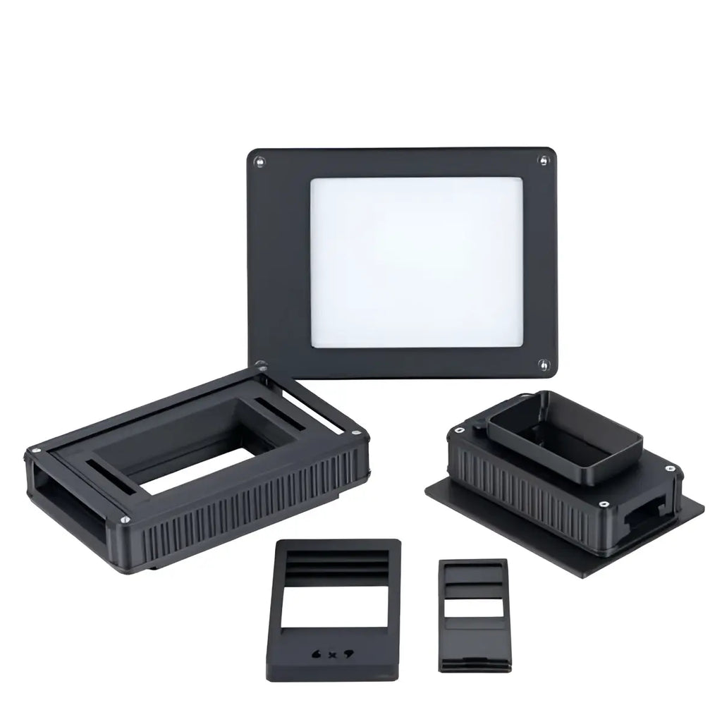 Black plastic smd component test fixture with rectangular slots and ridged sides.