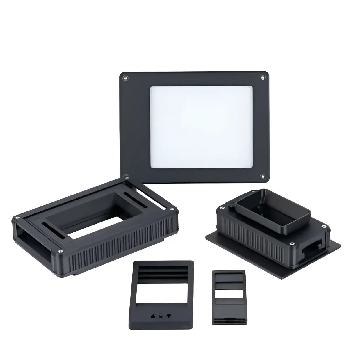 Black plastic smd component test fixture with rectangular slots and ridged sides.