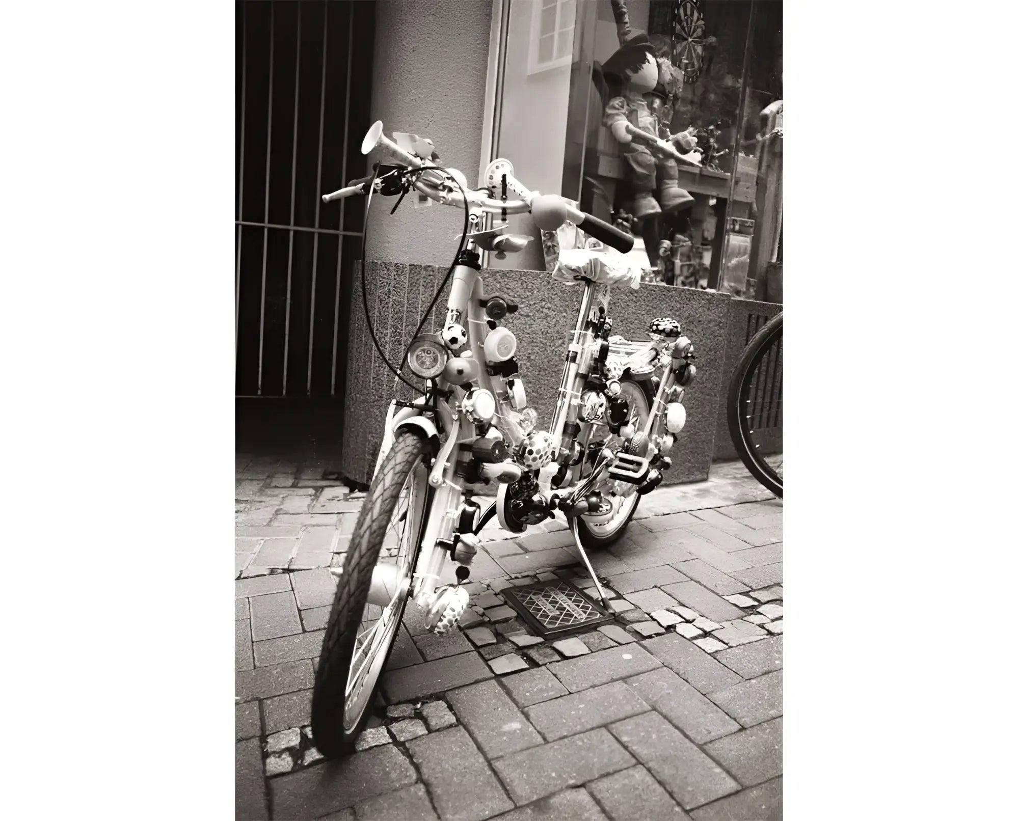 A whimsical, heavily modified bicycle with a chrome frame and handlebars adorned with various mechanical parts.
